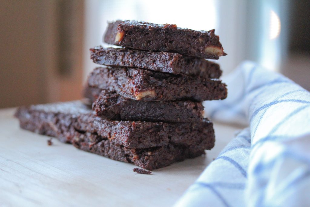 Chocolate vegan brownies that could double as a super healthy energy bar! Made with raw nuts, fruit, dates and cacao, you won't feel guilty eating these!