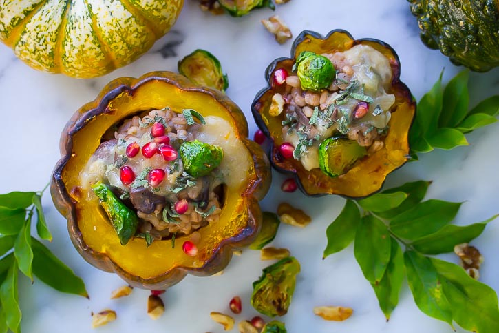 Vegan Baked Acorn Squash stuffed with mushroom barley pilaf. Perfectly easy and great for a fall dinner!