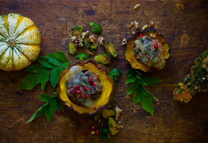 Vegan Baked Acorn Squash stuffed with mushroom barley pilaf. Perfectly easy and great for a fall dinner!