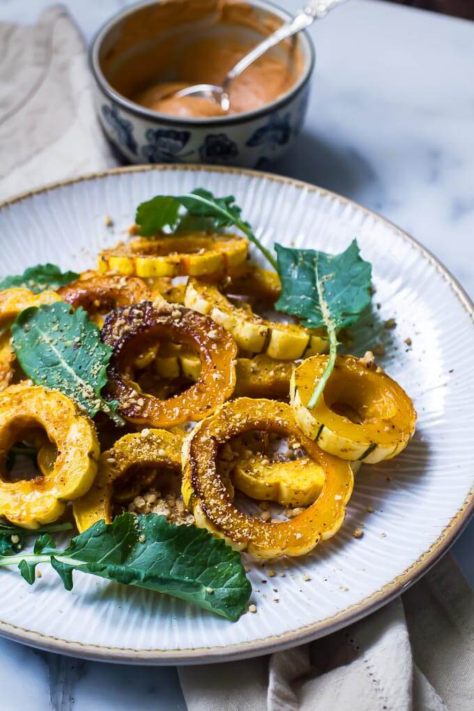 Harissa rubbed & oven roasted delicata squash with baby kale and savory pistachio crumble. These were so sweet and delicious! They are great as a side dish or chilled and added to salad.